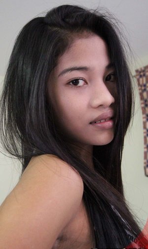 18 year old girl Katie Lewis stands naked after undressing in her bedroom